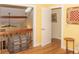Hallway featuring wood floors, a decorative trunk, and a view of the open living area at 152 Mansfield Blvd, Charleston, SC 29418