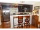 Well-equipped kitchen with breakfast bar, stainless steel refrigerator, and black cabinets and decor at 152 Mansfield Blvd, Charleston, SC 29418