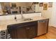 A lovely kitchen features granite counters, stainless dishwasher, and dark cabinets at 152 Mansfield Blvd, Charleston, SC 29418