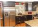 Well-equipped kitchen with stainless steel refrigerator, dark cabinets, and granite countertops at 152 Mansfield Blvd, Charleston, SC 29418