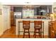 Charming kitchen featuring granite countertops, stainless steel appliances, and a convenient breakfast bar with two stools at 152 Mansfield Blvd, Charleston, SC 29418
