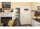 Comfortable living room with fireplace, mantel decorations, and door to porch at 152 Mansfield Blvd, Charleston, SC 29418