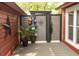 Outdoor shower area featuring wooden fence with nautical themed items with red siding on the home at 152 Mansfield Blvd, Charleston, SC 29418