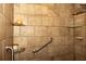 Elegant shower featuring tiled walls, glass shelving, and accessible grab bars at 152 Mansfield Blvd, Charleston, SC 29418