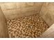 Close-up of a tiled shower floor with a decorative drain, showing detailed craftsmanship at 152 Mansfield Blvd, Charleston, SC 29418