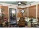 Bright sunroom with wicker seating, bamboo shades, and a vintage clock, perfect for relaxation at 152 Mansfield Blvd, Charleston, SC 29418