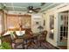 Cozy sunroom with bamboo shades, wicker chairs, ceiling fan and coastal decor for relaxation at 152 Mansfield Blvd, Charleston, SC 29418