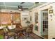 Comfortable sunroom with bamboo shades, wicker chairs, and a ceiling fan for a relaxing experience at 152 Mansfield Blvd, Charleston, SC 29418