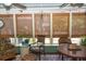 Inviting sunroom featuring woven shades, comfortable seating, and a vibrant rug for a cozy retreat at 152 Mansfield Blvd, Charleston, SC 29418