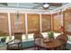 Sunroom with bamboo shades, rustic furnishings, and a ceiling fan for a relaxed atmosphere at 152 Mansfield Blvd, Charleston, SC 29418