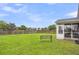 A spacious backyard featuring a bench, wooden fence, green grass, and view of surrounding neighborhood at 173 Southport Dr, Summerville, SC 29483