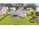 Aerial view of the fenced backyard with a screened porch and well-maintained lawn, offering privacy and space at 173 Southport Dr, Summerville, SC 29483