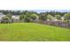 Large grassy backyard enclosed by a wooden fence and featuring mature trees and well-maintained lawn at 173 Southport Dr, Summerville, SC 29483