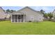 A well-manicured backyard featuring a screened-in porch and ample green space for outdoor activities at 173 Southport Dr, Summerville, SC 29483