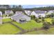 An elevated view shows a spacious backyard, framed by a wood fence and featuring a screened porch at 173 Southport Dr, Summerville, SC 29483