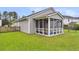 Home exterior featuring a screened-in porch and a well-maintained backyard with lush green grass at 173 Southport Dr, Summerville, SC 29483