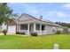 Home exterior with a welcoming front porch, solar panels, and well-maintained landscaping at 173 Southport Dr, Summerville, SC 29483