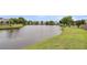 Scenic view of a tranquil pond surrounded by lush greenery and charming residential homes at 173 Southport Dr, Summerville, SC 29483