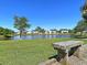Scenic pond view from a wooden bench, perfect for relaxation amidst the beauty of nature at 173 Southport Dr, Summerville, SC 29483