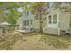 Presents a wooden deck with access to the house, surrounded by a green lawn and partial fence at 183 Civitas St, Mount Pleasant, SC 29464
