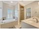 Bright bathroom featuring a soaking tub, glass shower, and double sinks at 183 Civitas St, Mount Pleasant, SC 29464