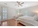 Bright, white bedroom featuring hardwood floors, neutral colors, and ample natural light from shuttered windows at 183 Civitas St, Mount Pleasant, SC 29464