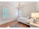 Bedroom with hardwood floors, chandelier and plantation shutters at 183 Civitas St, Mount Pleasant, SC 29464