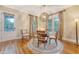 Inviting dining room with hardwood floors, charming chandelier, and sunlit windows create a pleasant atmosphere at 183 Civitas St, Mount Pleasant, SC 29464
