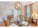 Cozy dining area with hardwood floors, globe chandelier, and views into the living room for open living at 183 Civitas St, Mount Pleasant, SC 29464