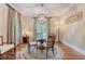 Refined dining room featuring hardwood floors, globe chandelier, and elegant drapes for a sophisticated touch at 183 Civitas St, Mount Pleasant, SC 29464