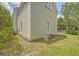 Shows the side exterior of the home with tidy yard and lush green foliage at 183 Civitas St, Mount Pleasant, SC 29464