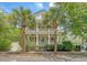 Charming two-story home with double porches framed by beautiful palm trees, embodying Southern charm at 183 Civitas St, Mount Pleasant, SC 29464