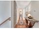 Upstairs hallway with hardwood flooring and a decorative table with lamps and decor at 183 Civitas St, Mount Pleasant, SC 29464
