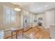 An eat-in kitchen is furnished with white cabinets, stainless steel appliances, a breakfast table, and wood floors at 183 Civitas St, Mount Pleasant, SC 29464