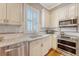 Bright kitchen featuring stainless steel appliances, granite countertops, and custom cabinets at 183 Civitas St, Mount Pleasant, SC 29464