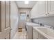 Functional laundry room with cabinets, a sink, a window, and modern washer and dryer for convenience at 183 Civitas St, Mount Pleasant, SC 29464