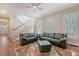Spacious living room with hardwood floors, a staircase, and plenty of natural light from shuttered windows at 183 Civitas St, Mount Pleasant, SC 29464