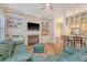 Inviting living room boasts a cozy fireplace, TV, built-in shelves, and open view to the kitchen at 183 Civitas St, Mount Pleasant, SC 29464