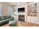 Bright living room with built-in shelving flanking a fireplace, with hardwood floors and natural light at 183 Civitas St, Mount Pleasant, SC 29464