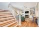 View of the staircase and living room that features a fireplace, built-in bookshelves, and hardwood floors at 183 Civitas St, Mount Pleasant, SC 29464