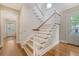 Traditional staircase featuring wood treads and white risers with a matching railing, complemented by hardwood floors at 183 Civitas St, Mount Pleasant, SC 29464
