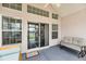 Relaxing back porch with fan, comfortable seating, and sliding glass doors to the home interior at 193 Cypress Forest Dr, Moncks Corner, SC 29461