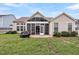 Spacious backyard featuring a screened-in porch and a well-maintained lawn at 193 Cypress Forest Dr, Moncks Corner, SC 29461