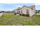 Well-manicured backyard with a green lawn, defined by a white picket fence and mature landscaping at 193 Cypress Forest Dr, Moncks Corner, SC 29461
