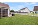 Spacious backyard with lush green grass, a charming white picket fence, and ample space for outdoor enjoyment at 193 Cypress Forest Dr, Moncks Corner, SC 29461