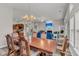A dining room with a view into the living room, with a modern TV over a fireplace and a contemporary sofa at 193 Cypress Forest Dr, Moncks Corner, SC 29461