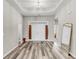 Elegant foyer featuring neutral walls, tray ceiling, a double door entry, and stylish hardwood floors at 193 Cypress Forest Dr, Moncks Corner, SC 29461