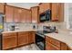 Kitchen featuring stainless steel appliances, stone backsplash, sleek countertops, and stylish wood cabinets at 193 Cypress Forest Dr, Moncks Corner, SC 29461