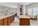 An open-concept kitchen featuring wood cabinets, an island, stainless steel appliances, and an eat-in breakfast nook at 193 Cypress Forest Dr, Moncks Corner, SC 29461
