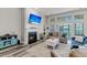Cozy living room featuring a fireplace, large windows, and stylish hardwood floors at 193 Cypress Forest Dr, Moncks Corner, SC 29461